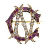 A late Victorian gold diamond and ruby monogram brooch. Designed as an entwined rose-cut diamond 'N'