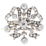 A late Victorian silver and gold diamond brooch. Designed as an old-cut diamond ribbon, with