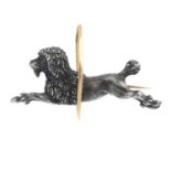 A late Victorian silver and gold dog brooch. Designed as an oxidized silver textured poodle, with