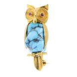 A mid 20th century turquoise and ruby brooch. Designed as a textured owl atop a perch, with free