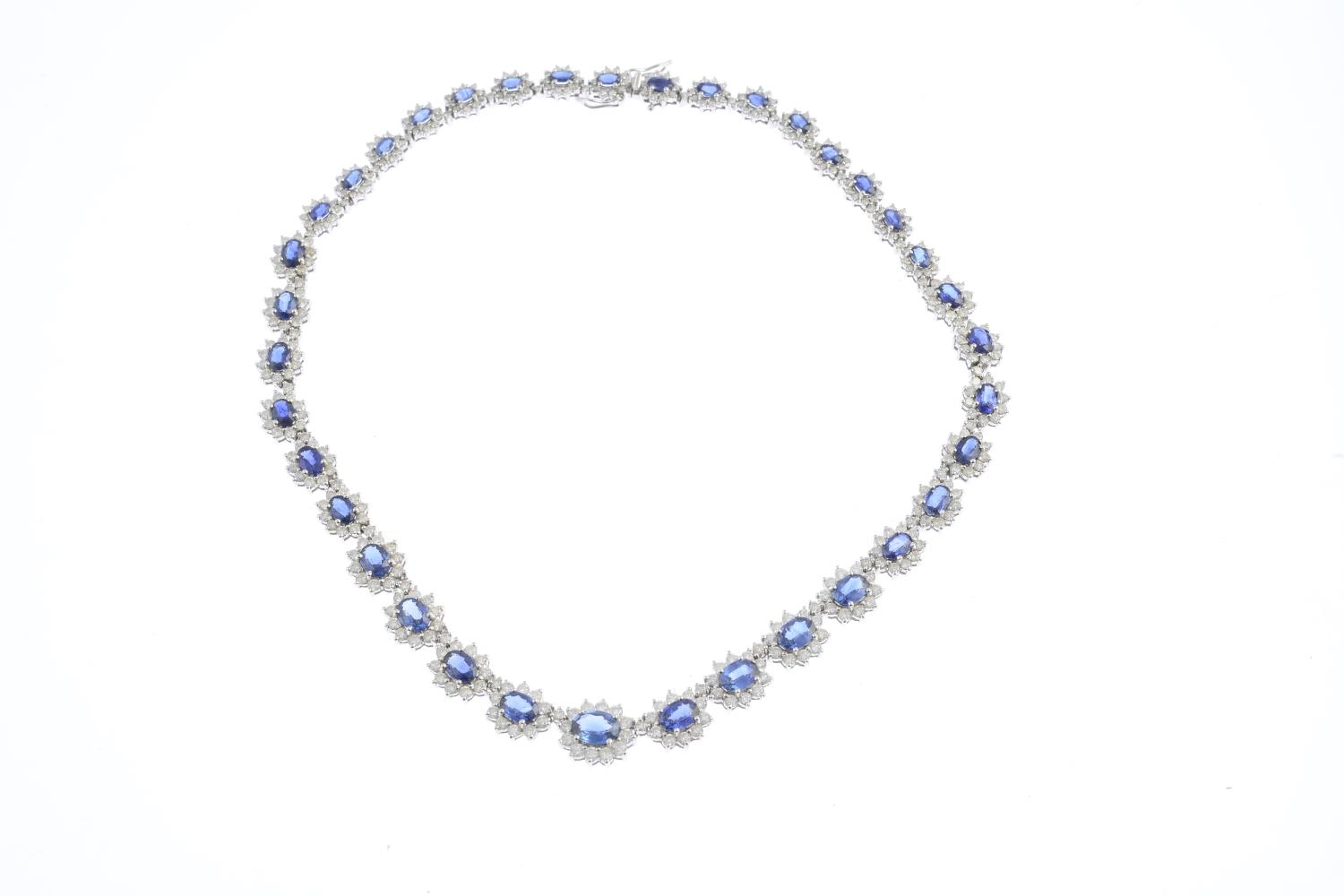 A sapphire and diamond necklace. Comprising a series of graduated oval-shape sapphire and - Image 2 of 3