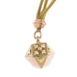 A late Victorian 9ct gold fob. Of bi-colour design, the foliate motif decagon, suspended from a