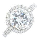 A diamond single-stone ring. The brilliant-cut diamond, with similarly-cut diamond halo and