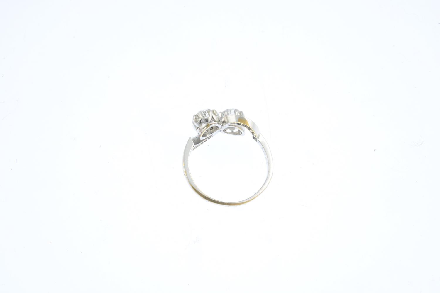 A diamond two-stone ring. Of asymmetric design, the old-cut diamonds, with rose-cut diamond - Image 2 of 3