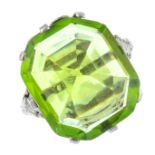 A peridot dress ring. The rectangular-shape peridot, with openwork foliate shoulders. Peridot weight