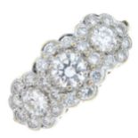 An 18ct gold diamond triple cluster ring. The graduated brilliant-cut diamond line, with similarly-