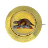 A gold reverse-carved intaglio brooch. The cabochon carved and painted to depict an otter upon