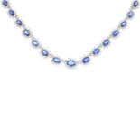 A sapphire and diamond necklace. Comprising a series of graduated oval-shape sapphire and