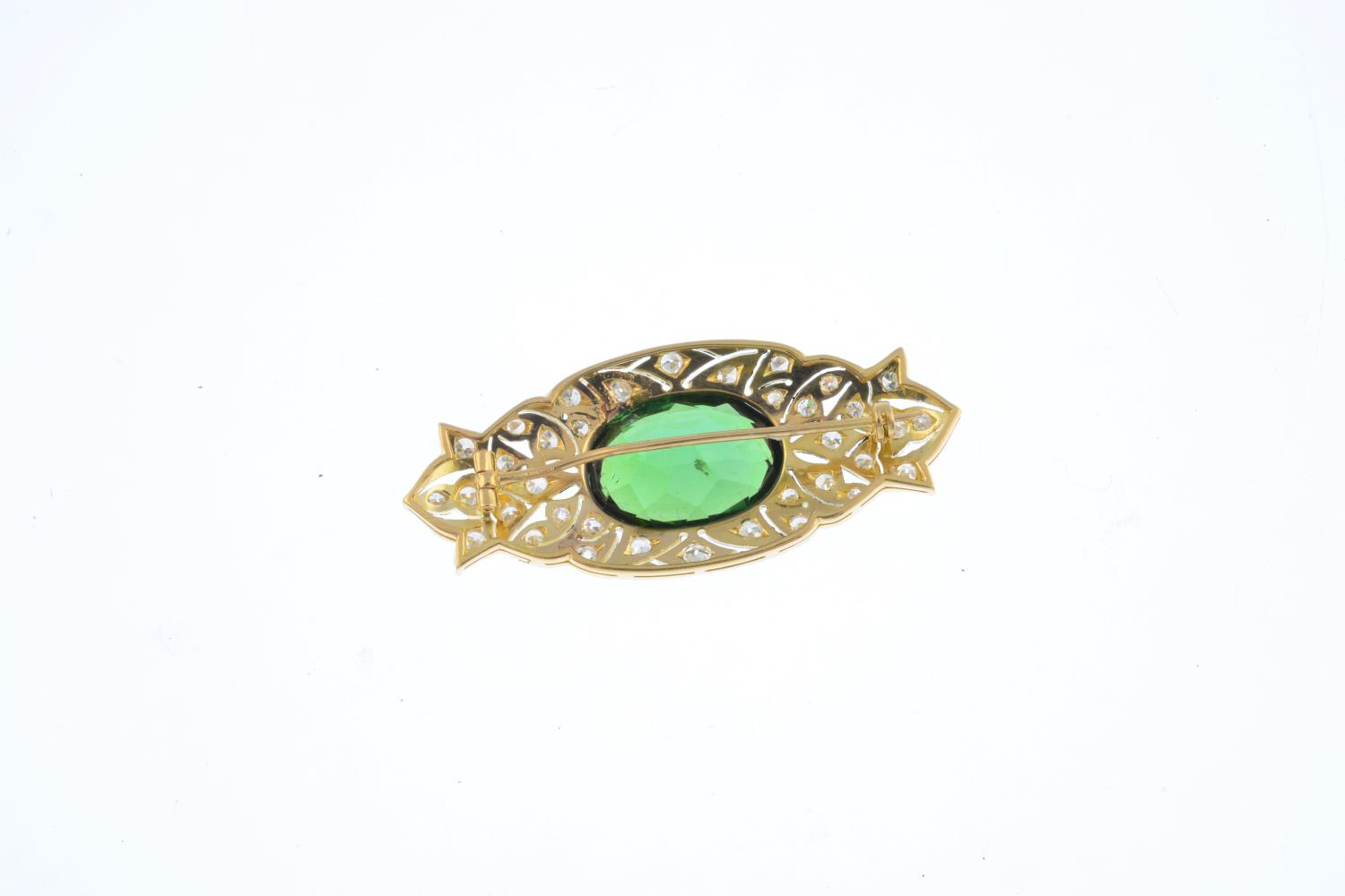 A tourmaline and diamond brooch. Of openwork design, the oval-shape green tourmaline, with - Image 2 of 2