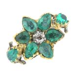 A diamond and emerald floral ring. The old-cut diamond, with pear-shape emerald petal surround and