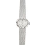 LONGINES - a lady's mid 20th century gold diamond watch. The oval dial, with brilliant-cut diamond