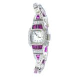 EBEL - a lady's Art Deco platinum, ruby and diamond cocktail watch. The cushion-shape dial, with