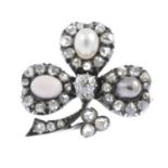 A late Victorian silver and gold, pearl and diamond brooch. Designed as a rose-cut diamond shamrock,