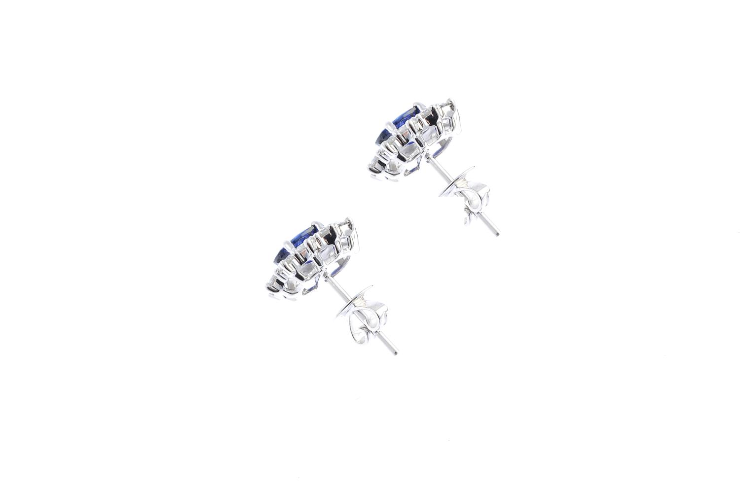 A pair of sapphire and diamond cluster earrings. Each designed as an oval-shape sapphire, with - Image 2 of 2