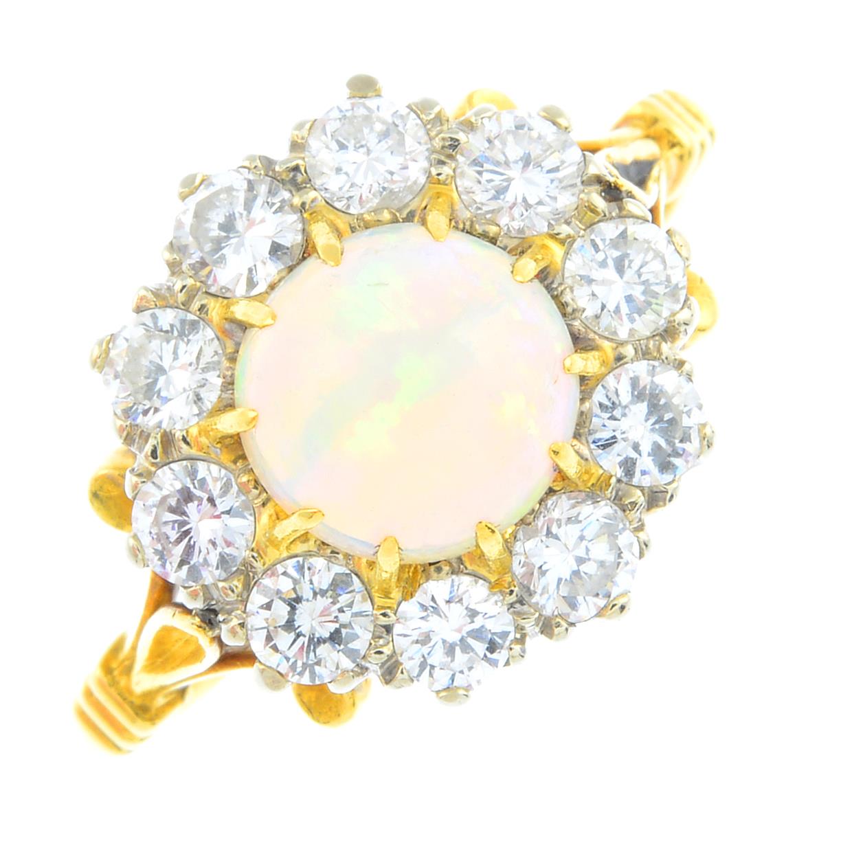 An 18ct gold opal and diamond cluster ring. The circular opal cabochon, with brilliant-cut diamond