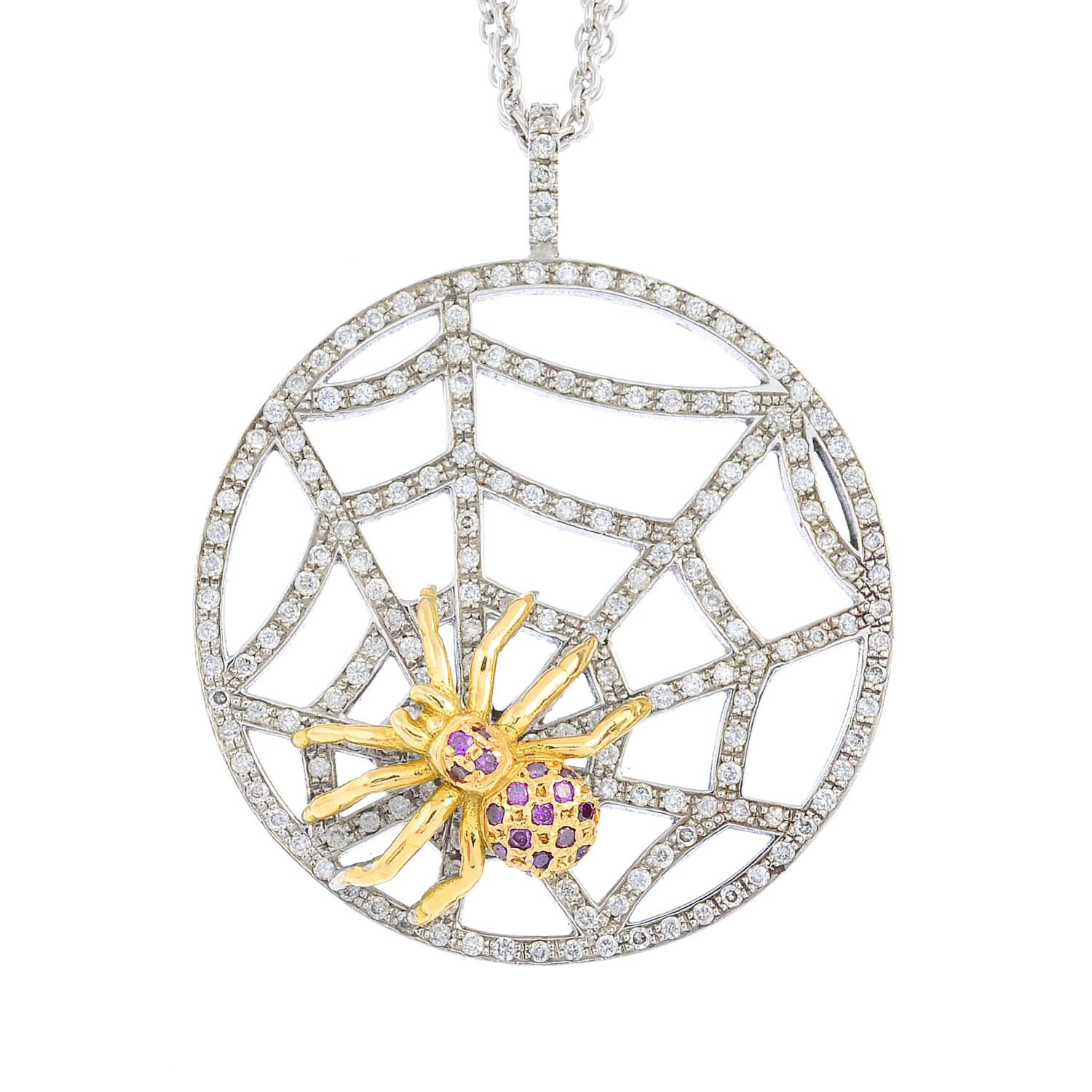 A sapphire and diamond pendant. Of bi-colour design, the purple sapphire spider, atop the diamond