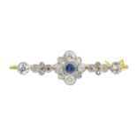 An early 20th century gold sapphire and diamond bar brooch. The circular-shape sapphire and old-