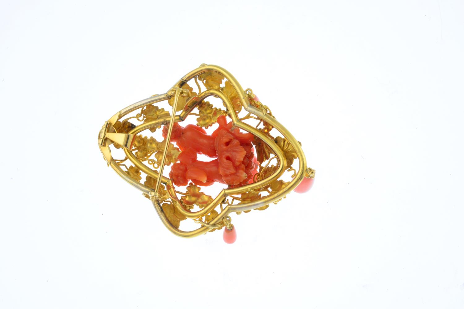 A mid Victorian gold coral brooch. The coral carved to depict Bacchus putting his hand to Cupid's - Image 2 of 2