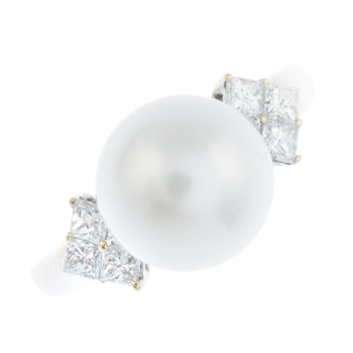 An 18ct gold diamond and cultured pearl dress ring. The cultured pearl, measuring 9.7mms, with