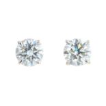 A pair of brilliant-cut diamond stud earrings.