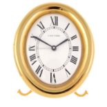 A desk alarm clock by Cartier. Gold plated case. Numbered 890806420. Quartz movement. White dial