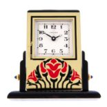 An alarm mantle clock by Cartier. Bi-material case. Numbered 890701769. Quartz movement. White