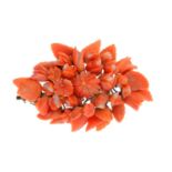 A coral brooch. Of marquise outline, the carved coral floral cluster, with similarly-carved coral