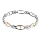 A diamond bangle. Designed as a series of pave-set diamond quatrefoils, with openwork curved bar and