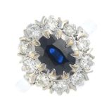 An 18ct gold sapphire and diamond cluster ring. The oval-shape sapphire, within a brilliant-cut