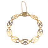 An early 20th century 15ct gold bracelet. Designed as a series of oval-shape openwork links, with