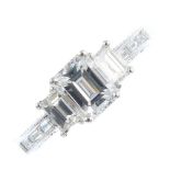 A diamond ring. The baguette-cut diamond, weighing 0.85ct, with similarly-cut diamond sides and