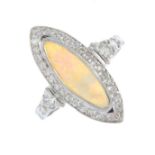 An opal and diamond cluster ring. The marquise-shape opal cabochon, within a vari-cut diamond