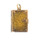 An early 20th century gold pendant. Of rectangular-shape outline, designed as a textured book,