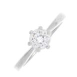 A platinum diamond single-stone ring. The brilliant-cut diamond, with tapered shoulders. Estimated