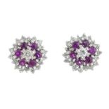 A pair of 18ct gold ruby and diamond cluster earrings. Each designed as a brilliant-cut diamond,