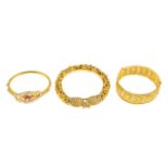 (210168) Three bangles. To include a glass-filled ruby and split pearl bangle, together with two