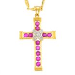 A ruby and diamond cross pendant. The circular-shape ruby crucifix, with pave-set diamond cross