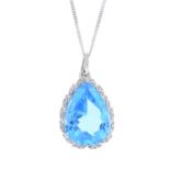 A 9ct gold topaz and diamond pendant. The pear-shape blue topaz, with single-cut diamond wreathe