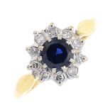 An 18ct gold sapphire and diamond cluster ring. The circular-shape sapphire, with single-cut diamond