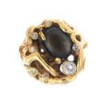 A 1970s star sapphire and diamond dress ring. Of openwork design, the oval brown star sapphire