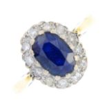 A sapphire and diamond cluster ring. The oval-shape sapphire, within a single-cut diamond