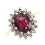 A garnet and diamond cluster ring. The oval-shape garnet, with single-cut diamond surround.