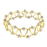 An 18ct gold diamond bracelet. Of openwork design, comprising a series of alternately oriented