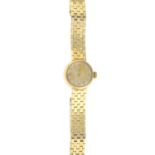 OMEGA - a ladies mid 20th century 9ct gold wrist watch. The circular dial, with brick-link