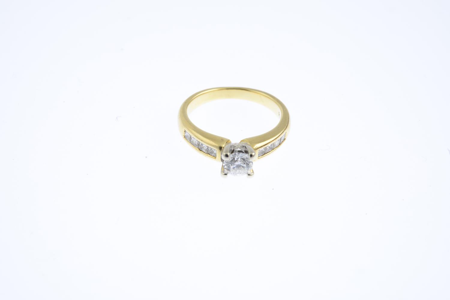 A diamond single-stone ring. The brilliant-cut diamond, with square-shape diamond line sides. - Image 3 of 3