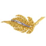 A sapphire brooch. Designed as a textured leaf, with circular-shape sapphire line highlight.