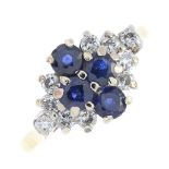 An 18ct gold sapphire and diamond dress ring. The circular-shape sapphire quatrefoil, with