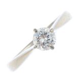 An 18ct gold diamond single-stone ring. The brilliant-cut diamond, with tapered shoulders. With