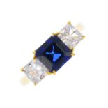 An 18ct gold synthetic sapphire and cubic zirconia three-stone ring. The square-shape synthetic