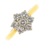 An 18ct gold diamond cluster ring. The brilliant-cut diamond, with similarly-cut diamond surround.